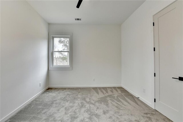 unfurnished bedroom with connected bathroom, light carpet, and ceiling fan