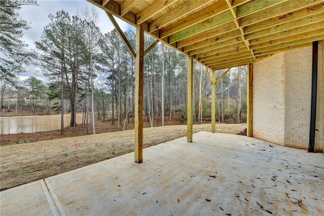 unfurnished bedroom with ceiling fan, multiple windows, ensuite bath, and light carpet