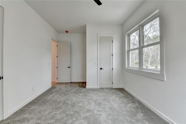 unfurnished bedroom featuring light colored carpet