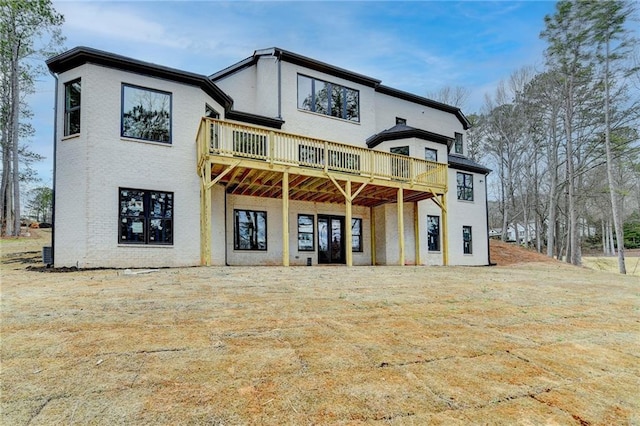 rear view of house featuring a wooden deck