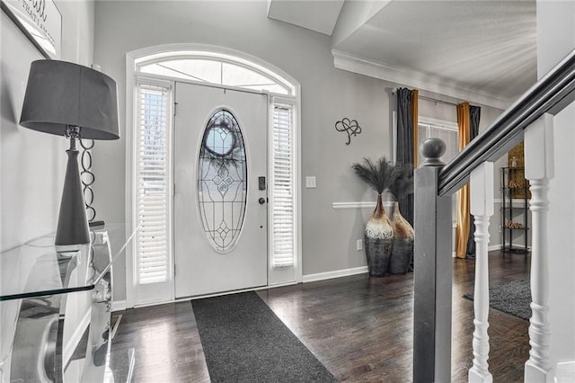 entrance foyer featuring crown molding and dark hardwood / wood-style flooring