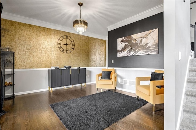 living area with crown molding, dark hardwood / wood-style flooring, and a chandelier