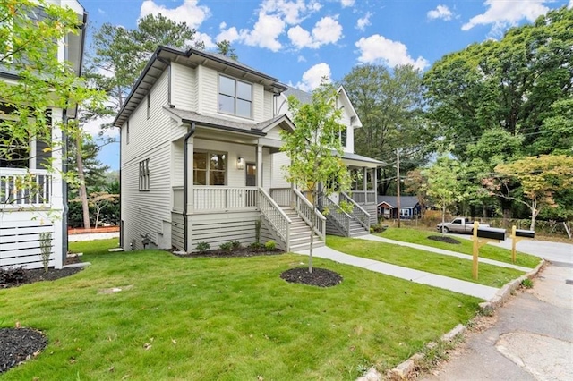 view of front of home featuring covered porch and a front yard