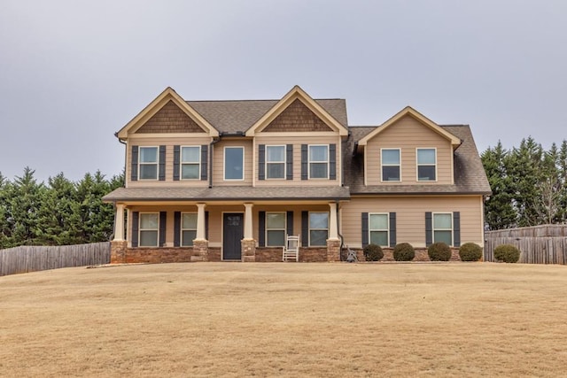 craftsman-style home featuring a porch and a front lawn