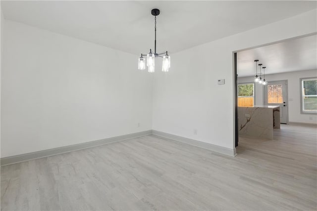 spare room with light hardwood / wood-style flooring