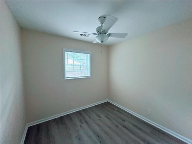 empty room featuring dark hardwood / wood-style floors and ceiling fan