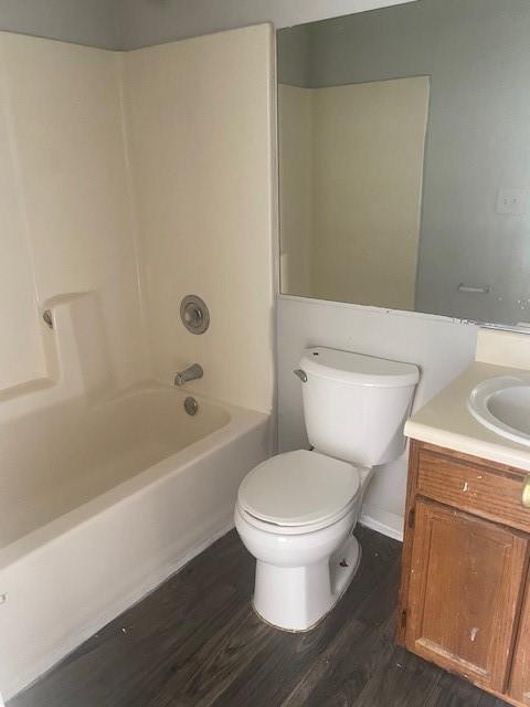 bathroom with toilet, wood finished floors, and vanity