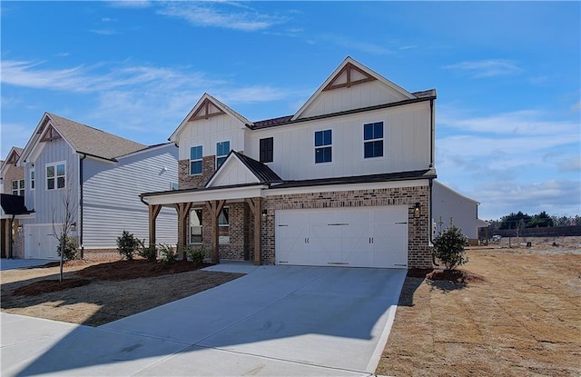 view of front of property with an attached garage, brick siding, board and batten siding, and driveway