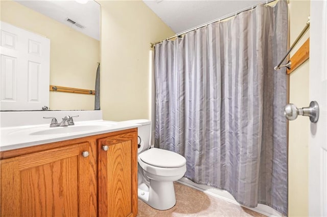 bathroom featuring tile patterned floors, vanity, and toilet