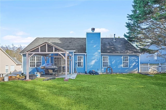 rear view of house featuring a patio area and a lawn