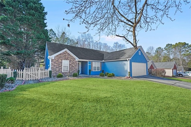 ranch-style home with a front lawn and a garage