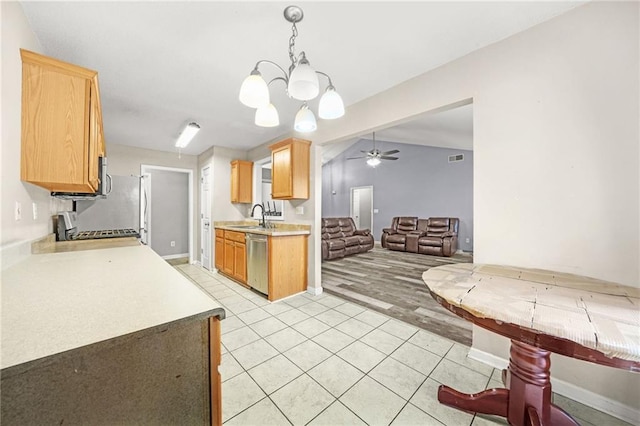 kitchen with stainless steel dishwasher, ceiling fan with notable chandelier, sink, range, and hanging light fixtures