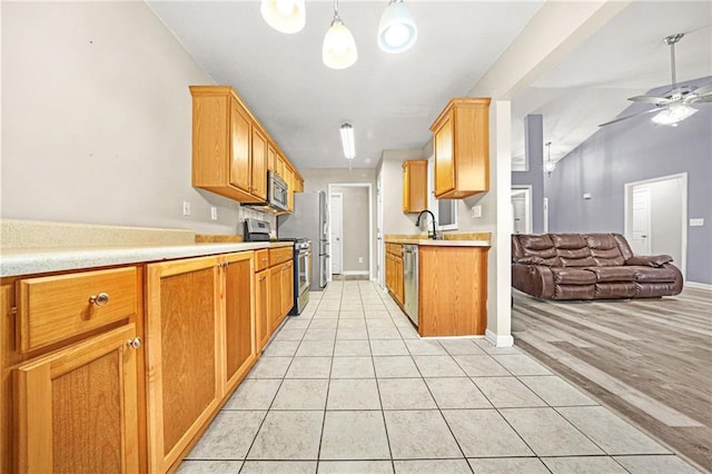 kitchen featuring appliances with stainless steel finishes, light tile patterned floors, ceiling fan, and pendant lighting