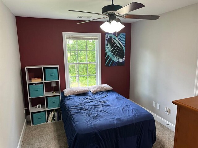bedroom with baseboards, ceiling fan, carpet flooring, and visible vents