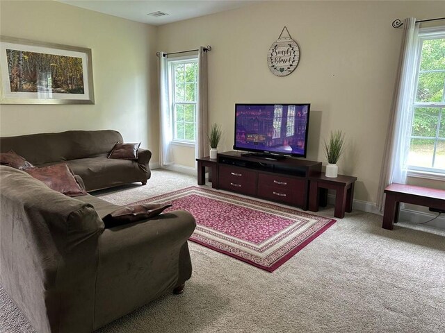 living room with carpet flooring, baseboards, and visible vents