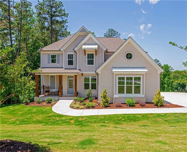 1013 Liberty Springs Dr, Woodstock, GA 30188 - craftsman-style home featuring board and batten siding, covered porch, brick siding, and a front lawn