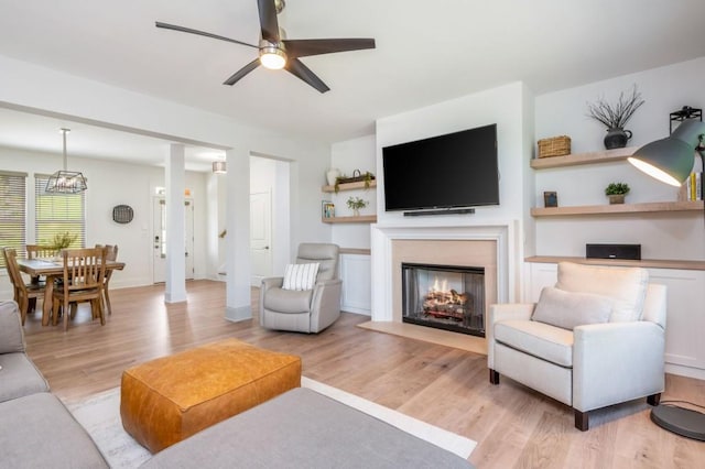 1013 Liberty Springs Dr, Woodstock, GA 30188 - living room with a ceiling fan, light wood-type flooring, and a fireplace with flush hearth