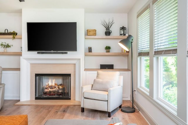 1013 Liberty Springs Dr, Woodstock, GA 30188 - sitting room featuring wood finished floors and a lit fireplace