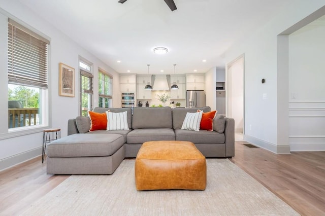 1013 Liberty Springs Dr, Woodstock, GA 30188 - living room featuring light wood-style flooring, baseboards, ceiling fan, and recessed lighting