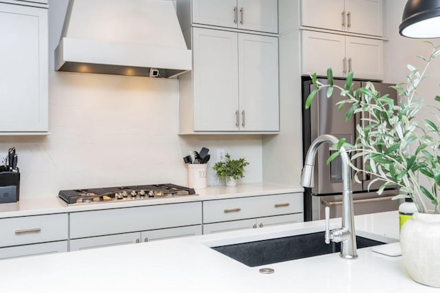 1013 Liberty Springs Dr, Woodstock, GA 30188 - kitchen with custom range hood, appliances with stainless steel finishes, light countertops, and decorative backsplash