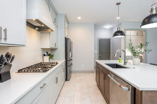 1013 Liberty Springs Dr, Woodstock, GA 30188 - kitchen with appliances with stainless steel finishes, a sink, custom range hood, light countertops, and an island with sink