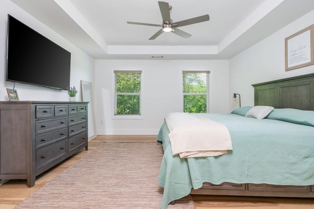 1013 Liberty Springs Dr, Woodstock, GA 30188 - bedroom with a tray ceiling, light wood-style floors, baseboards, and ceiling fan