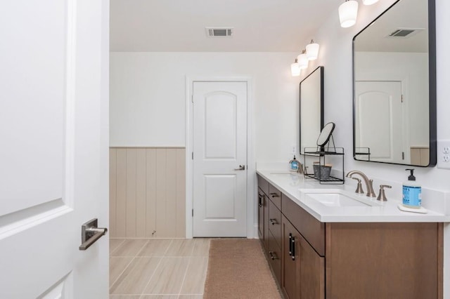 1013 Liberty Springs Dr, Woodstock, GA 30188 - bathroom featuring double vanity, tile patterned flooring, a wainscoted wall, and wooden walls