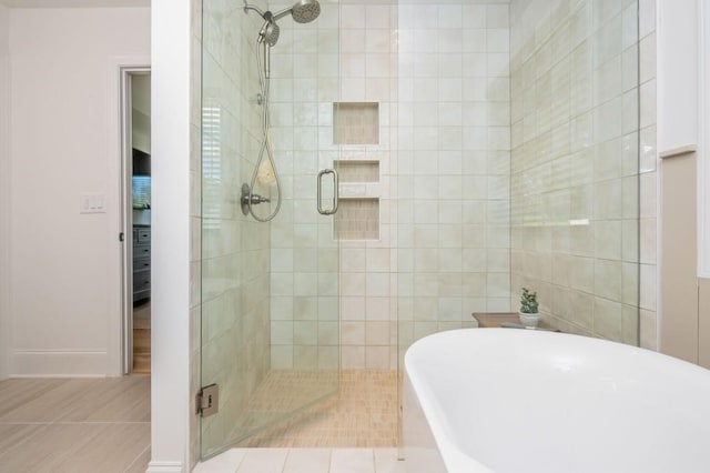 1013 Liberty Springs Dr, Woodstock, GA 30188 - bathroom featuring a shower stall, a freestanding tub, and baseboards