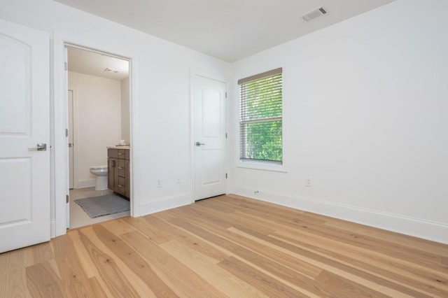 1013 Liberty Springs Dr, Woodstock, GA 30188 - unfurnished bedroom with light wood-style floors, baseboards, and ensuite bath