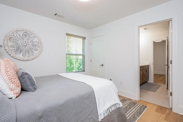 1013 Liberty Springs Dr, Woodstock, GA 30188 - bedroom featuring light wood-style flooring, connected bathroom, and baseboards