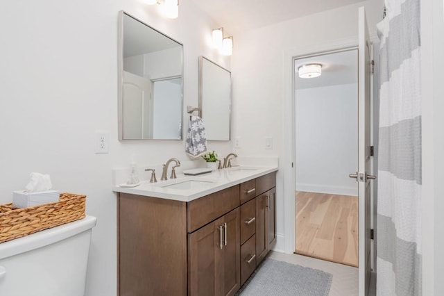 1013 Liberty Springs Dr, Woodstock, GA 30188 - bathroom with toilet, double vanity, and wood finished floors