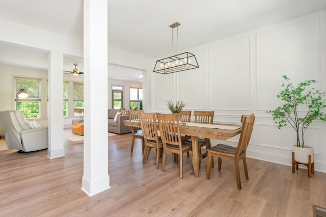 1013 Liberty Springs Dr, Woodstock, GA 30188 - dining space featuring a decorative wall, light wood-type flooring, ceiling fan, and a chandelier