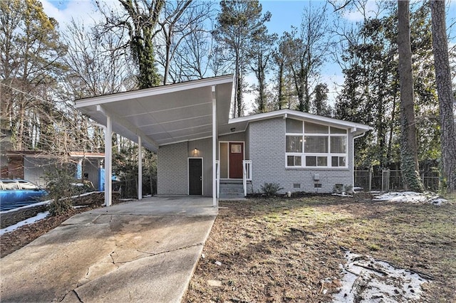 view of front facade featuring a carport and a sunroom