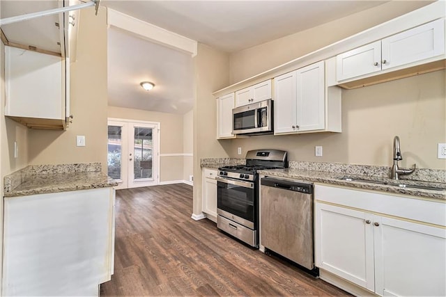 kitchen featuring appliances with stainless steel finishes, white cabinetry, french doors, and sink