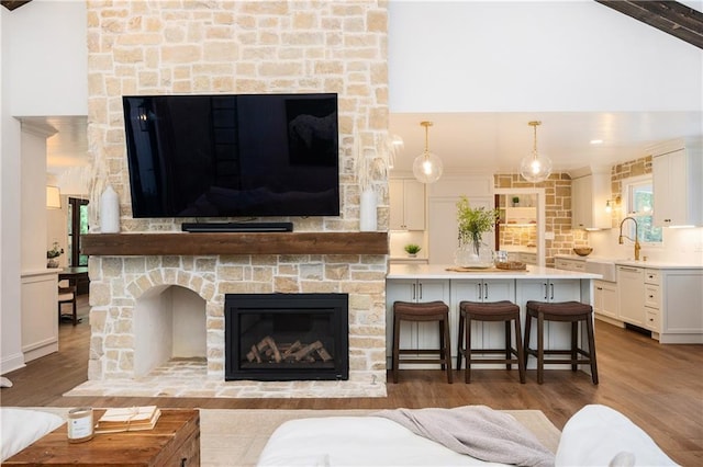 12410 Charlotte Dr, Alpharetta, GA 30004 - living area featuring a stone fireplace and wood finished floors