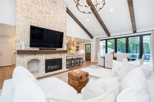 12410 Charlotte Dr, Alpharetta, GA 30004 - living area with light wood finished floors, a chandelier, beamed ceiling, high vaulted ceiling, and a stone fireplace