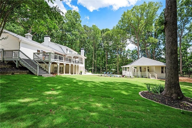 12410 Charlotte Dr, Alpharetta, GA 30004 - view of green lawn featuring stairway and a wooden deck