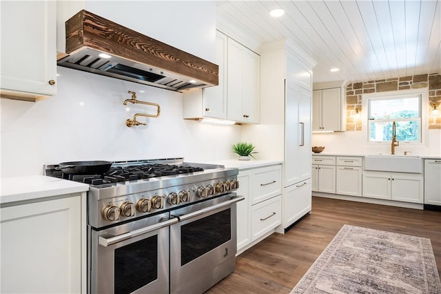12410 Charlotte Dr, Alpharetta, GA 30004 - kitchen with high end appliances, custom exhaust hood, white cabinets, light countertops, and wood ceiling