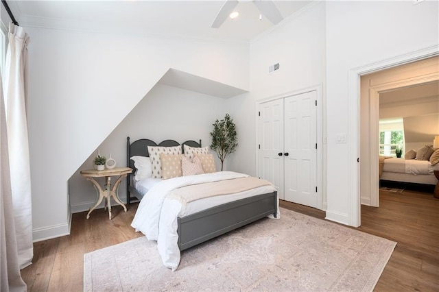 12410 Charlotte Dr, Alpharetta, GA 30004 - bedroom with ornamental molding, wood finished floors, vaulted ceiling, a ceiling fan, and a closet