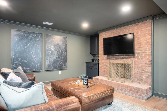 12410 Charlotte Dr, Alpharetta, GA 30004 - living room with wood finished floors, ornamental molding, recessed lighting, and a fireplace