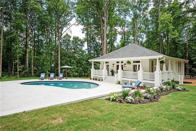 12410 Charlotte Dr, Alpharetta, GA 30004 - swimming pool featuring a lawn, a patio, a porch, and view of wooded area