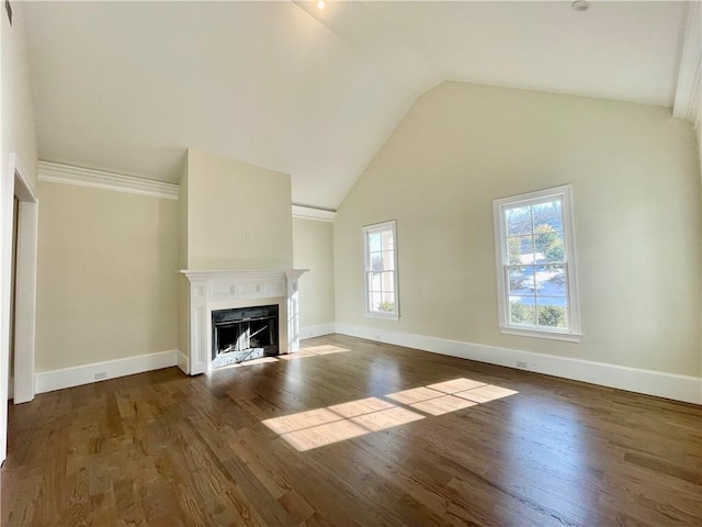 unfurnished living room featuring high vaulted ceiling and dark wood-type flooring