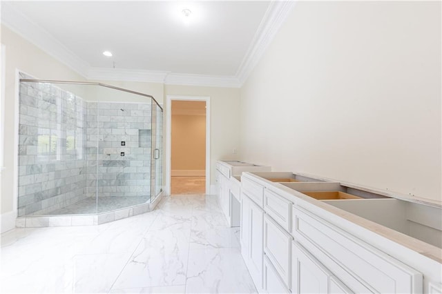 bathroom featuring a shower with shower door, vanity, and crown molding