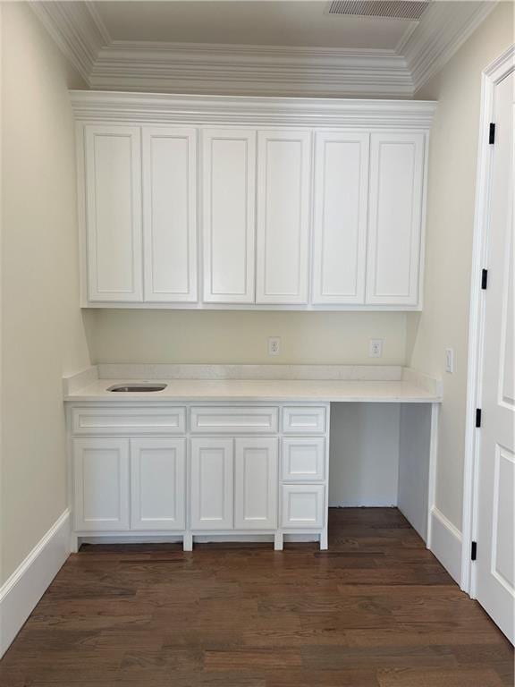 unfurnished office featuring dark hardwood / wood-style floors and ornamental molding