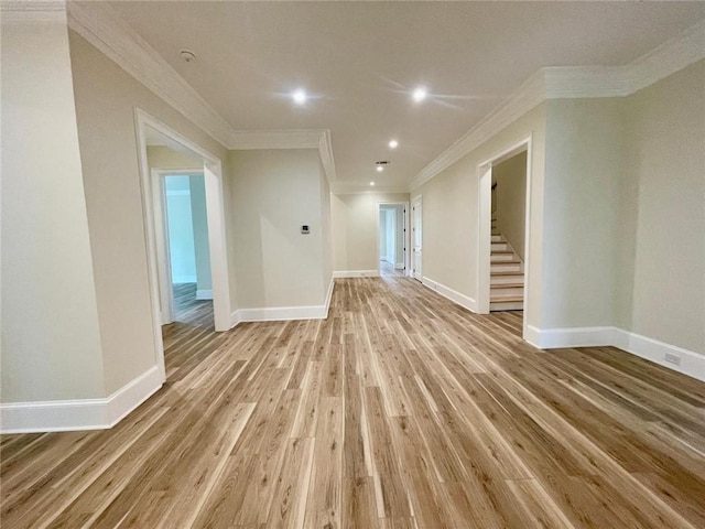 empty room with light wood-type flooring and ornamental molding