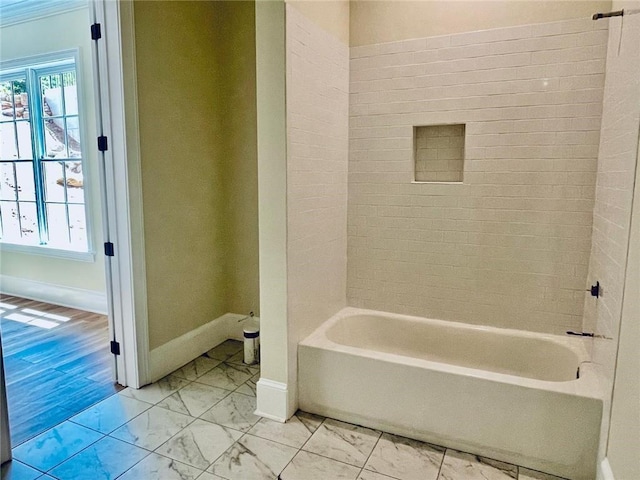 bathroom featuring tiled shower / bath and plenty of natural light