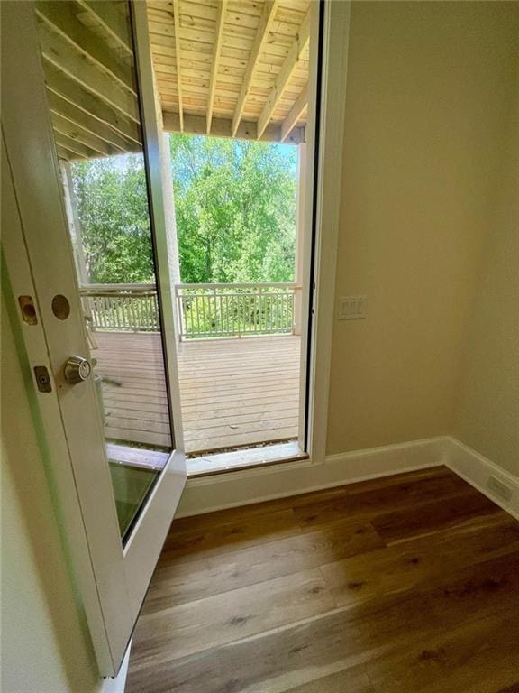 doorway to outside with hardwood / wood-style flooring and wood ceiling