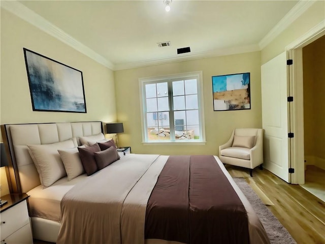 bedroom featuring ornamental molding and light wood-type flooring