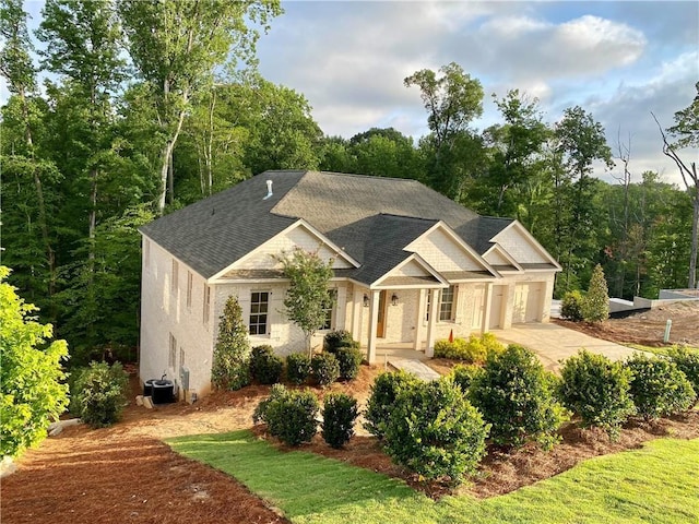 view of front of property with central AC and a garage