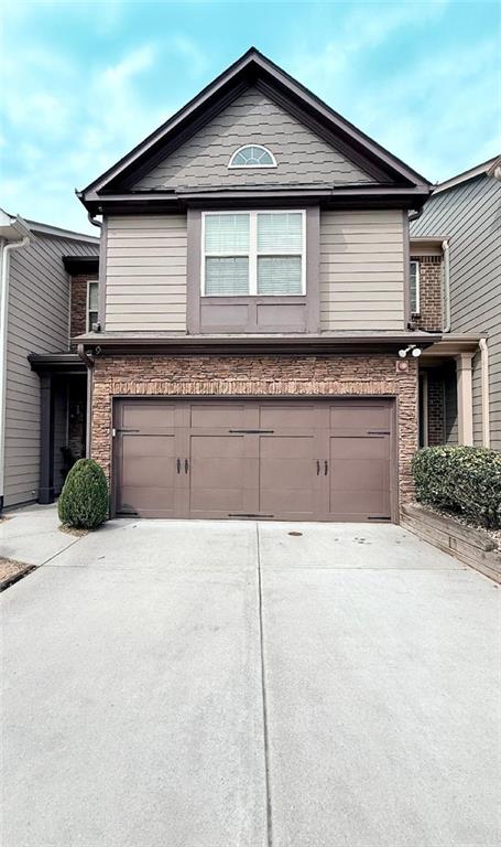 view of front of property with driveway and a garage